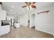 Bright, open kitchen and dining area with stainless steel appliances and modern lighting at 6518 Paw Pl, Land O Lakes, FL 34639