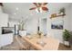Virtually staged kitchen and dining area featuring stainless steel appliances and wood dining table at 6518 Paw Pl, Land O Lakes, FL 34639