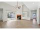 Bright living room featuring vaulted ceilings, a fireplace, and access to outdoor patio at 6518 Paw Pl, Land O Lakes, FL 34639