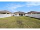Backyard featuring a well-maintained lawn surrounded by a white privacy fence at 672 Old Windsor Way, Spring Hill, FL 34609