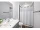 Bathroom featuring a sink with a mirror, a shower with a white curtain, and wood-look flooring at 672 Old Windsor Way, Spring Hill, FL 34609