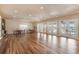Spacious clubhouse interior with tables, chairs, and multiple French door exits to the pool at 672 Old Windsor Way, Spring Hill, FL 34609
