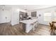 Modern kitchen with gray cabinets, quartz countertops, stainless steel appliances, and wood-look tile flooring at 672 Old Windsor Way, Spring Hill, FL 34609