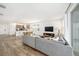 Bright, open living space featuring wood-look tile floors, and seamless connection to the kitchen and dining areas at 672 Old Windsor Way, Spring Hill, FL 34609
