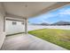 Covered patio provides shade and overlooks the fenced backyard at 672 Old Windsor Way, Spring Hill, FL 34609