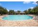 Large, clear community pool with a clubhouse and lounge chairs nearby at 672 Old Windsor Way, Spring Hill, FL 34609