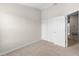 Bright bedroom with plush carpet, closet, and doorway, perfect for personalization at 6872 40Th N Ln, Pinellas Park, FL 33781