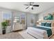 A bright bedroom features a ceiling fan, windows with views, and contemporary decor at 6872 40Th N Ln, Pinellas Park, FL 33781