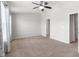 Spacious bedroom with a ceiling fan, carpeted floors, and neutral color scheme at 6872 40Th N Ln, Pinellas Park, FL 33781