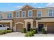 Charming two-story townhome with a well-maintained lawn and attached garage, creating a welcoming curb appeal at 6872 40Th N Ln, Pinellas Park, FL 33781