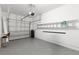 Spacious garage with epoxy flooring, ladder and water softener provides ample storage and functionality at 6872 40Th N Ln, Pinellas Park, FL 33781
