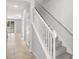 Bright hallway with tile flooring leading to a carpeted staircase and a view of the backyard at 6872 40Th N Ln, Pinellas Park, FL 33781