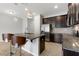 Modern kitchen features stainless steel appliances, granite countertops, and an open island layout with bar stool seating at 6872 40Th N Ln, Pinellas Park, FL 33781