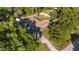 An aerial view of a property with a fenced backyard surrounded by mature trees provides privacy at 6907 W Creek Dr, Tampa, FL 33615