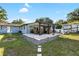 Large fenced-in backyard with stone patio dining and seating area and RV parking area at 6907 W Creek Dr, Tampa, FL 33615