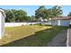 Expansive backyard featuring lush lawn and mature trees for your enjoyment and outdoor activities at 6907 W Creek Dr, Tampa, FL 33615
