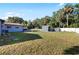 Spacious backyard with shed, patio dining set, seating, and lush lawn, perfect for outdoor enjoyment at 6907 W Creek Dr, Tampa, FL 33615