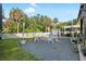 Backyard with a firepit and white fence surrounded by lush greenery and shady trees at 6907 W Creek Dr, Tampa, FL 33615