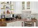 Close-up of the bar area with marble countertops, wine fridge, and decorative shelves at 6907 W Creek Dr, Tampa, FL 33615