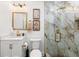 Modern bathroom boasts luxurious glass enclosed shower, marble tile and gold fixtures at 6907 W Creek Dr, Tampa, FL 33615