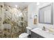 Bathroom features a modern glass enclosed shower, marble tile and granite countertops at 6907 W Creek Dr, Tampa, FL 33615