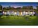 Dusk view of a cozy home with a manicured lawn, and inviting front facade with decorative landscape at 6907 W Creek Dr, Tampa, FL 33615