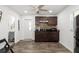 Small kitchen area, with stainless steel sink, microwave, and wooden cabinets at 6907 W Creek Dr, Tampa, FL 33615
