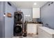 Laundry room features modern appliances, cabinetry, and counter space at 6907 W Creek Dr, Tampa, FL 33615