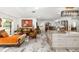 Bright, open-concept living area seamlessly connects to a modern kitchen with granite countertops at 6907 W Creek Dr, Tampa, FL 33615