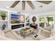 Cozy living room featuring a fireplace, large TV, comfortable seating, and access to outdoor space at 6907 W Creek Dr, Tampa, FL 33615