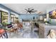 Enjoy the outdoor kitchen with bar seating, ceiling fan and entertainment area at 6907 W Creek Dr, Tampa, FL 33615