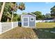 A well-maintained, blue outdoor shed with a window and white trim provides extra storage at 6907 W Creek Dr, Tampa, FL 33615