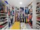 Spacious walk-in closet with custom shelving, hanging rods, and bench seating at 6907 W Creek Dr, Tampa, FL 33615