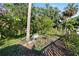 Backyard garden area with tropical plants, a small raised bed, and perimeter fencing at 6907 W Creek Dr, Tampa, FL 33615