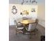 Comfortable dining area features a round wooden table and chairs, perfect for Gathering meals and gatherings at 7645 Sun Island S Dr # 306, South Pasadena, FL 33707