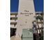 The Saratoga condominium building featuring a clean exterior design with lush, green landscaping at 7645 Sun Island S Dr # 306, South Pasadena, FL 33707