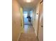 Well-lit hallway with tile flooring, featuring multiple closets for storage and leading to the living area at 7645 Sun Island S Dr # 306, South Pasadena, FL 33707