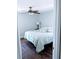 Clean bedroom with light walls, wood-look floors, and ceiling fan for added comfort at 8004 25Th W Ave, Bradenton, FL 34209