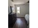 Bedroom featuring a large dresser with TV and a window with bright sunlight at 8004 25Th W Ave, Bradenton, FL 34209