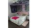 Modern bedroom with LED headboard lighting, decorative wall hangings and hardwood flooring at 8004 25Th W Ave, Bradenton, FL 34209