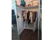 Mirrored closet with a single shelf and hanging rod filled with various clothing items at 8004 25Th W Ave, Bradenton, FL 34209