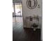 Foyer featuring glass table with decorative plant on dark hardwood floors at 8004 25Th W Ave, Bradenton, FL 34209