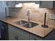 The granite countertop complements the stainless steel sink and tiled backsplash at 8004 25Th W Ave, Bradenton, FL 34209