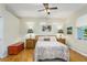Cozy bedroom featuring a comfortable bed, wood floors, and stylish lamps on matching bedside tables at 8116 Sanguinelli Rd, Land O Lakes, FL 34637