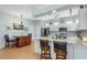 Spacious kitchen featuring an island with seating, white cabinets, and modern appliances at 8116 Sanguinelli Rd, Land O Lakes, FL 34637