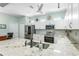 Bright kitchen featuring white cabinetry, stainless steel appliances, and a granite countertop island at 8116 Sanguinelli Rd, Land O Lakes, FL 34637