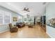 Spacious living room with tile flooring, comfortable seating, and abundant natural light from large windows at 8116 Sanguinelli Rd, Land O Lakes, FL 34637