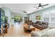 Inviting living room with tiled floors, large windows, and comfortable seating, creating a cozy atmosphere at 8116 Sanguinelli Rd, Land O Lakes, FL 34637
