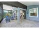 Spacious covered patio with brick flooring, comfortable seating, and seamless indoor-outdoor living at 8116 Sanguinelli Rd, Land O Lakes, FL 34637