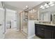 Bathroom features shower, sink with granite countertops, and a view into the laundry room at 8227 Bird Whistle Ln, Land O Lakes, FL 34637